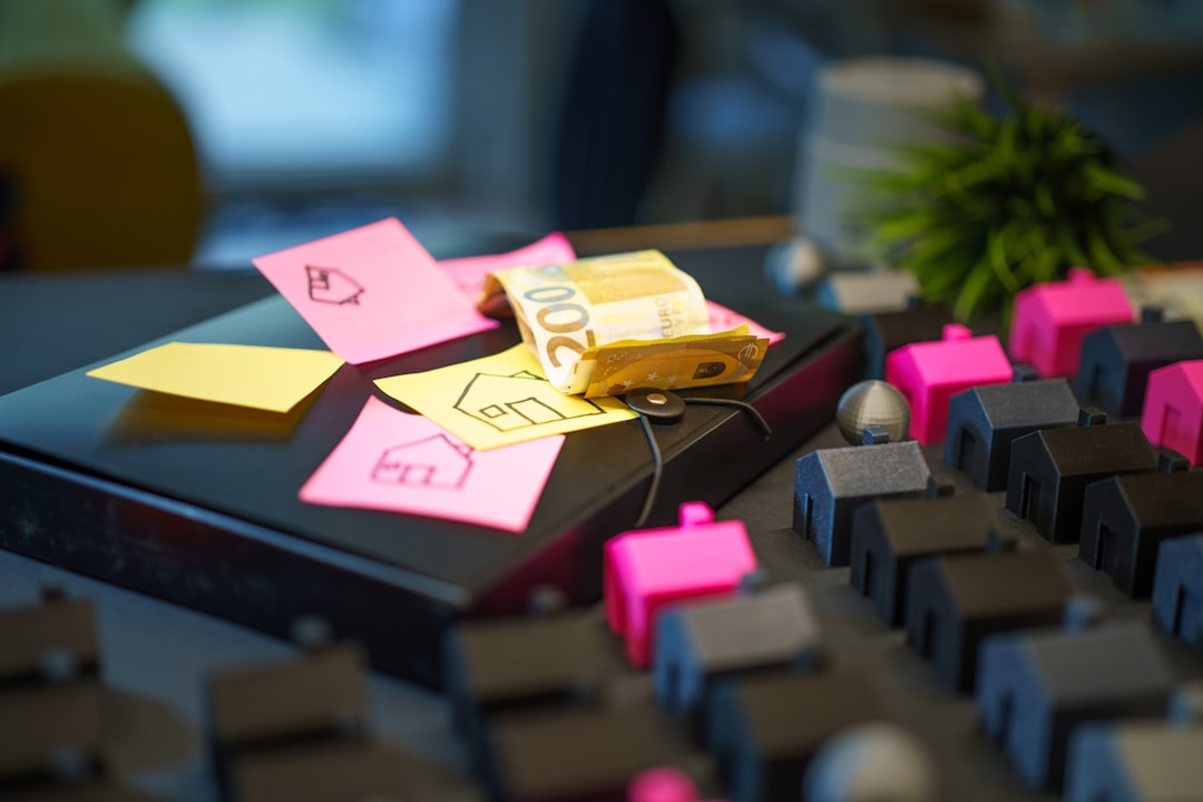 Real estate budget planning property investment euro money. Conceptual photo showing financial preparation, housing market strategy, euro banknotes, sticky notes with house drawings and model homes